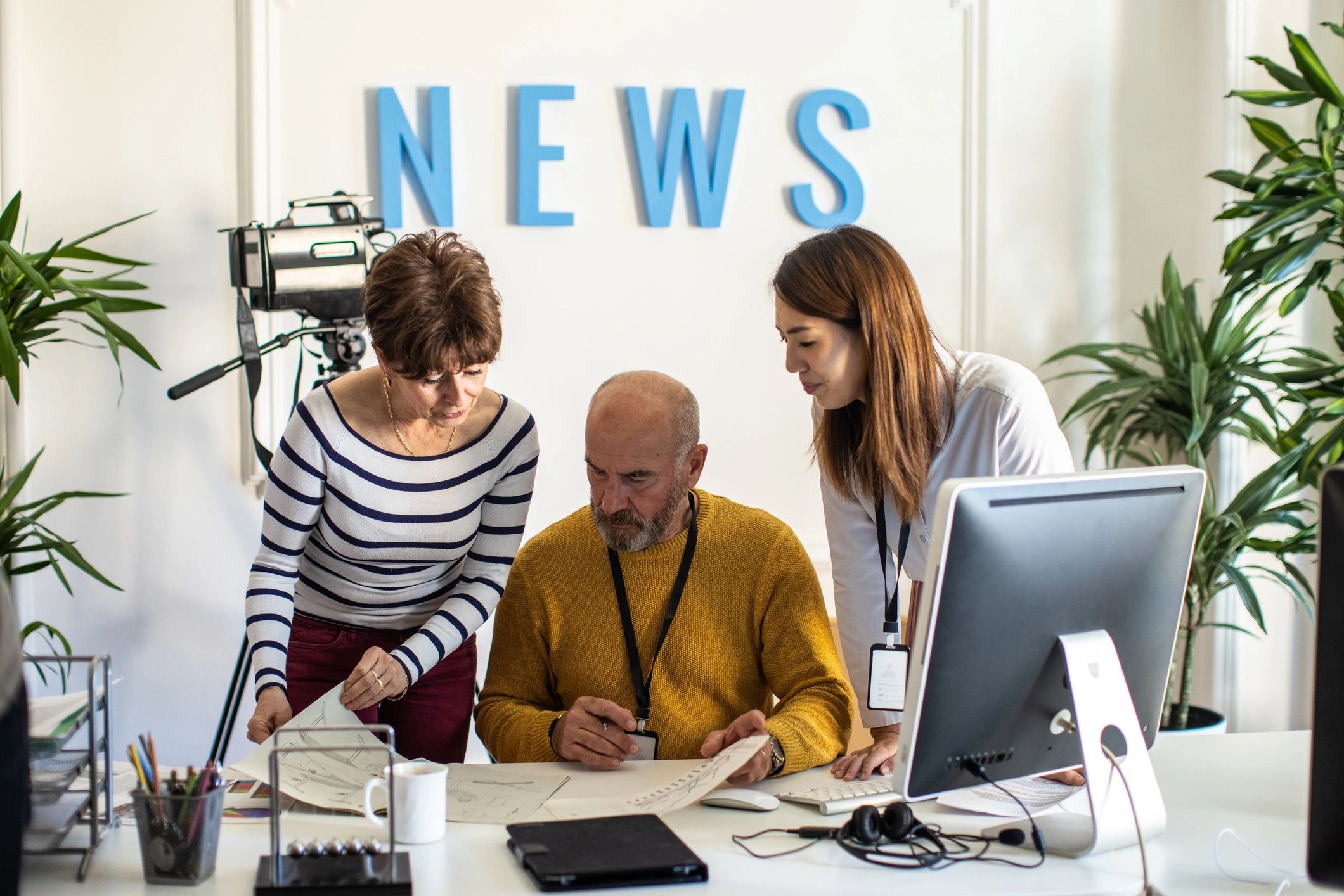 Editorial team meeting in a modern newsroom