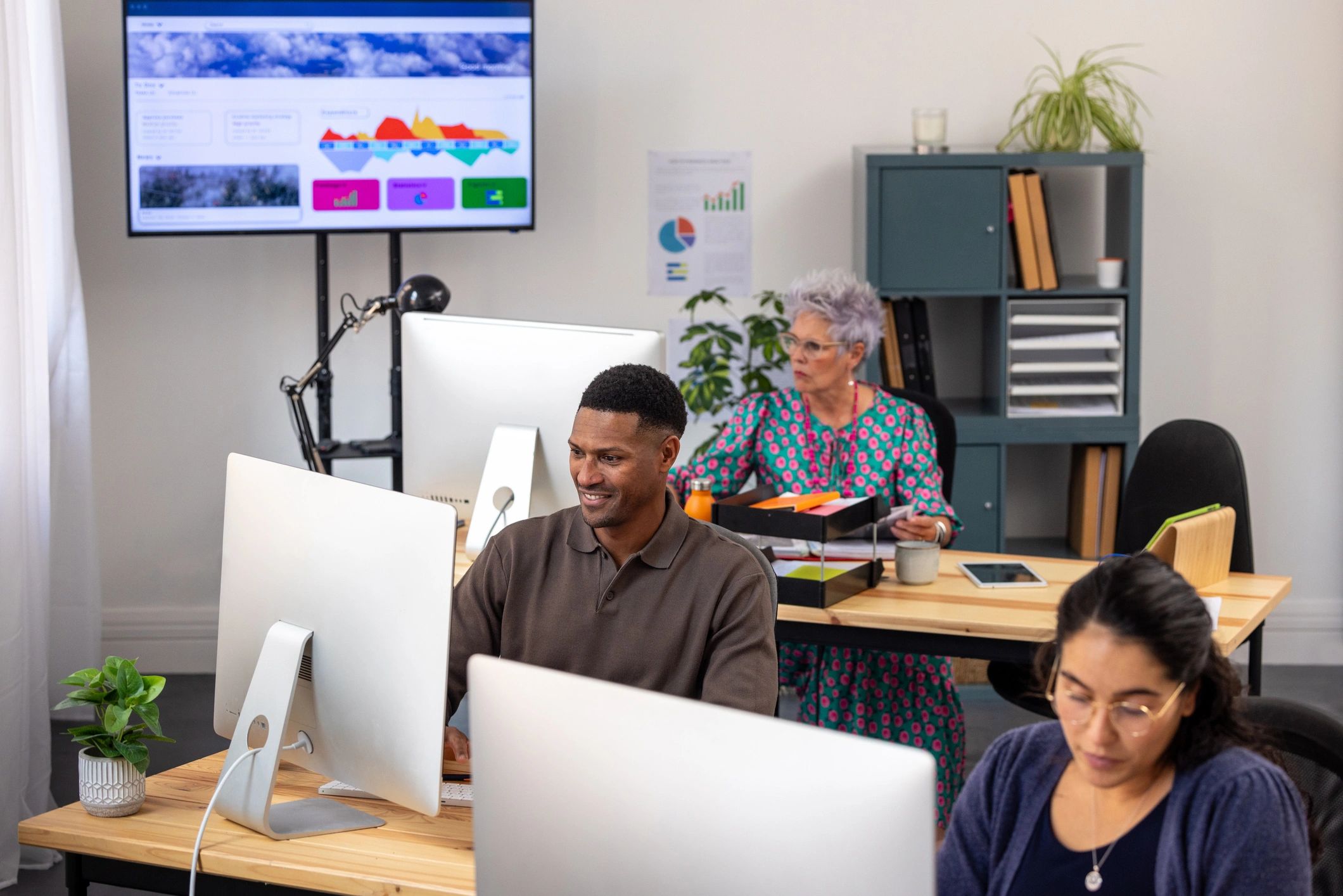 Editorial-style business workspace with charts and team collaboration