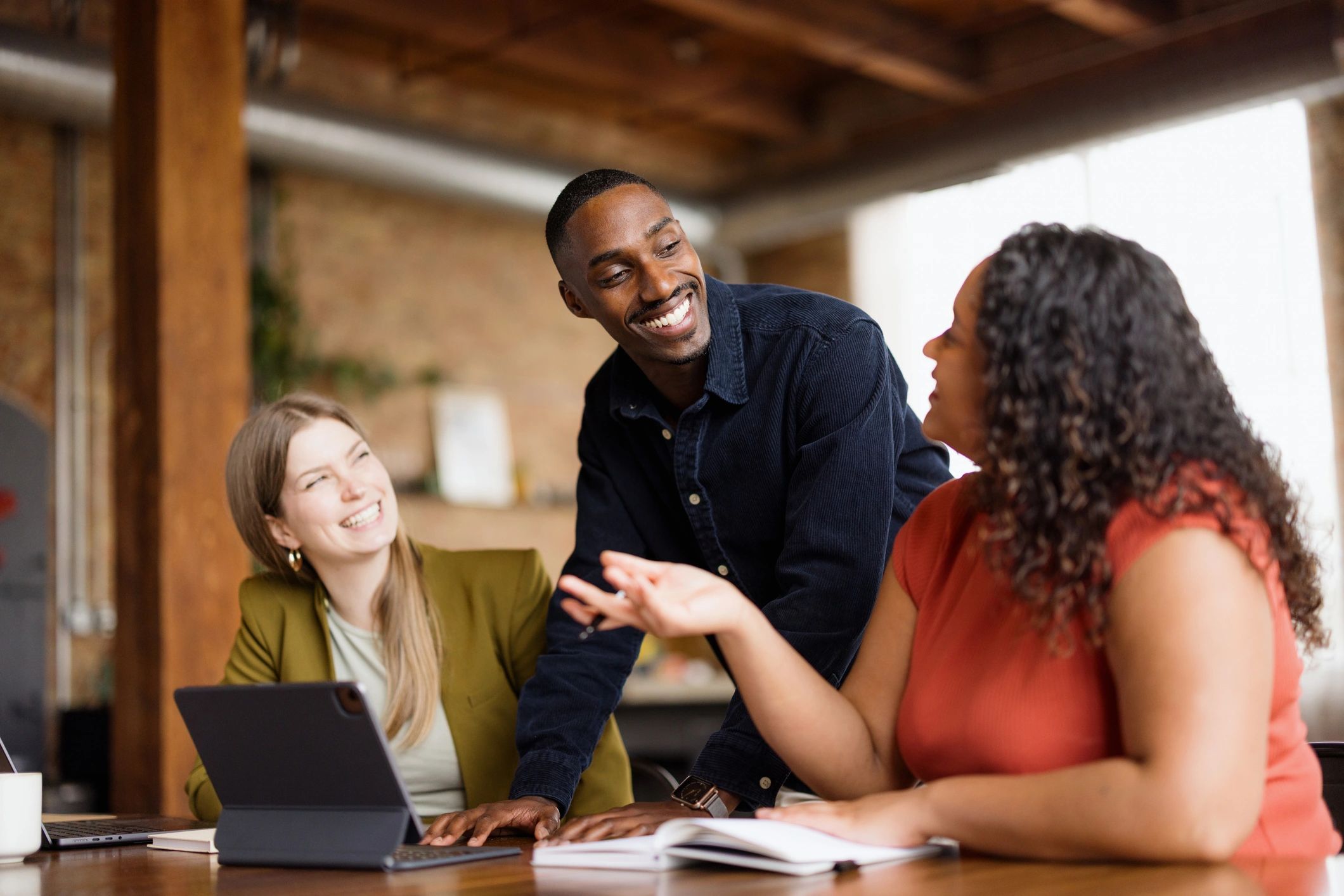Business professional speaking with colleagues during a meeting